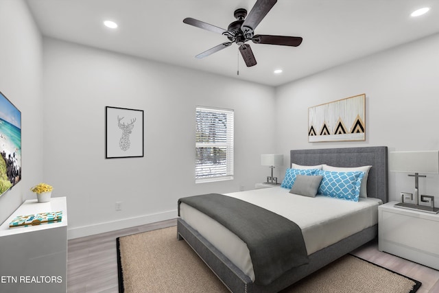 bedroom with ceiling fan and hardwood / wood-style flooring