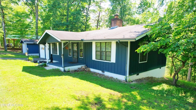 2109 Key Way, Sevierville, TN 37876 - view of front facade with a porch, a chimney, a front lawn, crawl space, and roof with shingles