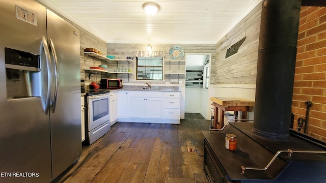 2109 Key Way, Sevierville, TN 37876 - kitchen with appliances with stainless steel finishes, dark wood-type flooring, white cabinets, open shelves, and a wood stove