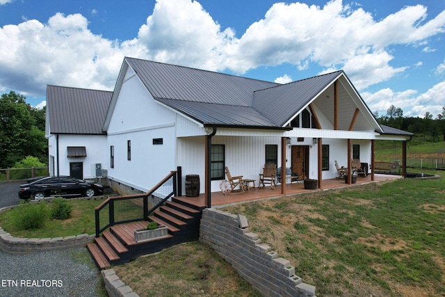 exterior space with covered porch and a front lawn