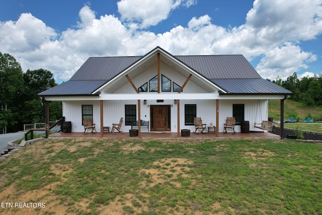 modern farmhouse featuring a front yard and a porch