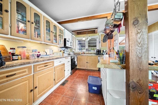 kitchen featuring sink, tile patterned flooring, light brown cabinetry, beam ceiling, and stainless steel appliances