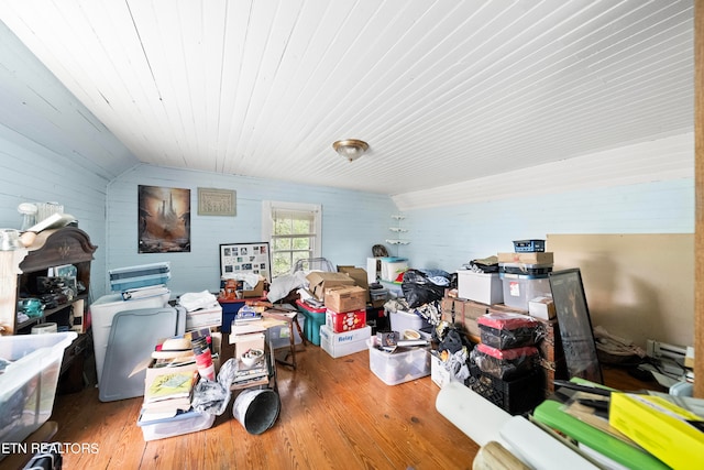 miscellaneous room featuring vaulted ceiling and hardwood / wood-style flooring