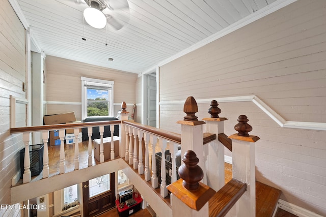 corridor featuring crown molding, brick wall, and wooden ceiling