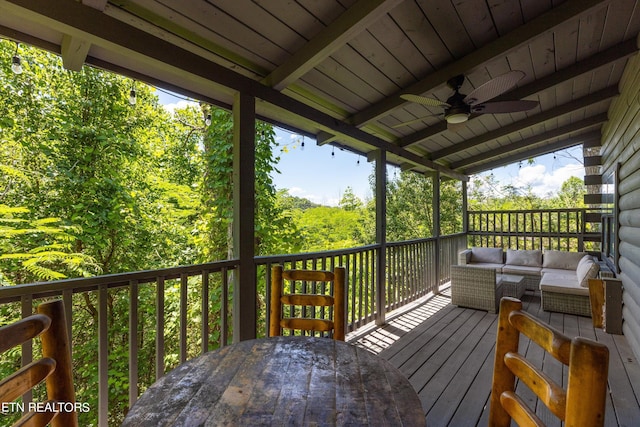 wooden deck with ceiling fan and outdoor lounge area