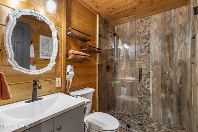 bathroom featuring an enclosed shower, vanity, wooden walls, toilet, and wooden ceiling