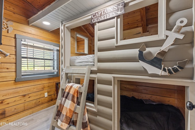 interior space with hardwood / wood-style floors, rustic walls, and wooden walls