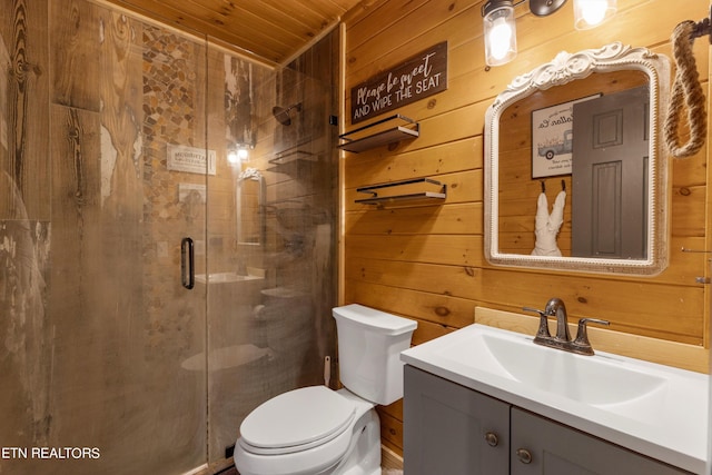 bathroom with vanity, wooden walls, toilet, a shower with shower door, and wooden ceiling