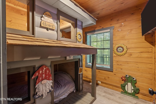 interior details with hardwood / wood-style floors, wood walls, and wood ceiling