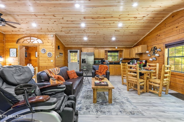 living room with light wood-type flooring, wooden ceiling, lofted ceiling, and wooden walls