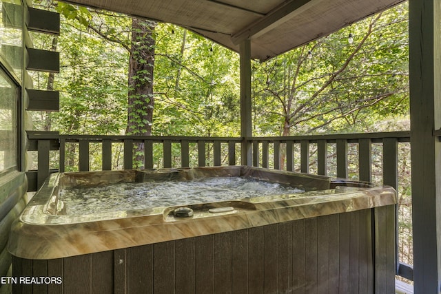 wooden deck featuring a hot tub