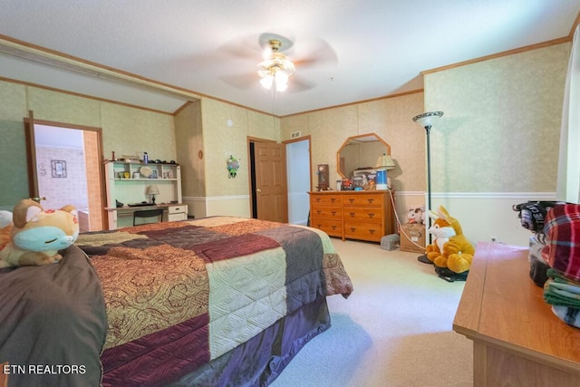 carpeted bedroom with ceiling fan and ornamental molding