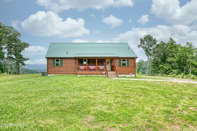 log-style house with a front lawn and a porch