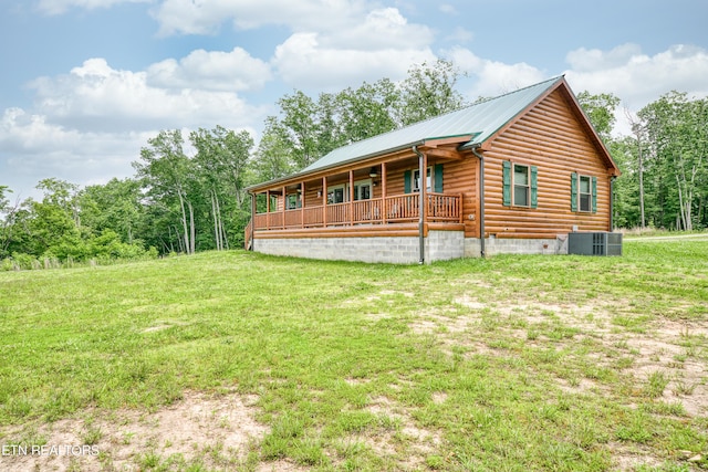 view of home's exterior featuring a yard, a porch, and central AC