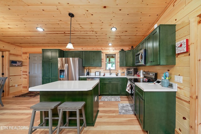 kitchen featuring wood ceiling, green cabinets, stainless steel appliances, pendant lighting, and light hardwood / wood-style flooring