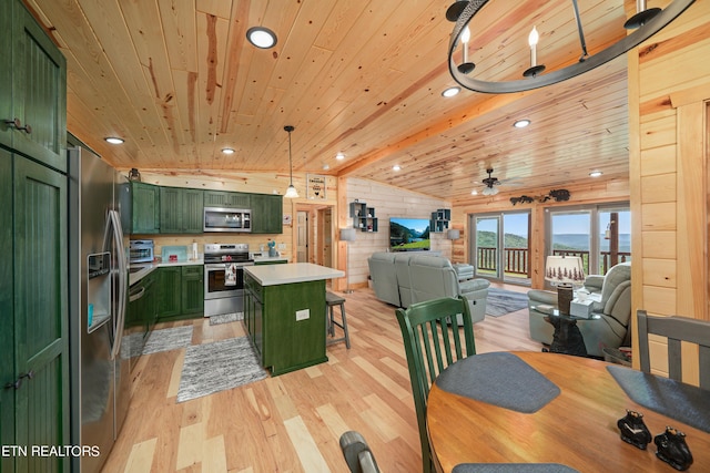 kitchen with a center island, decorative light fixtures, stainless steel appliances, ceiling fan, and green cabinets