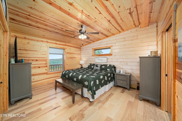 bedroom with lofted ceiling, ceiling fan, wood walls, light hardwood / wood-style flooring, and wooden ceiling