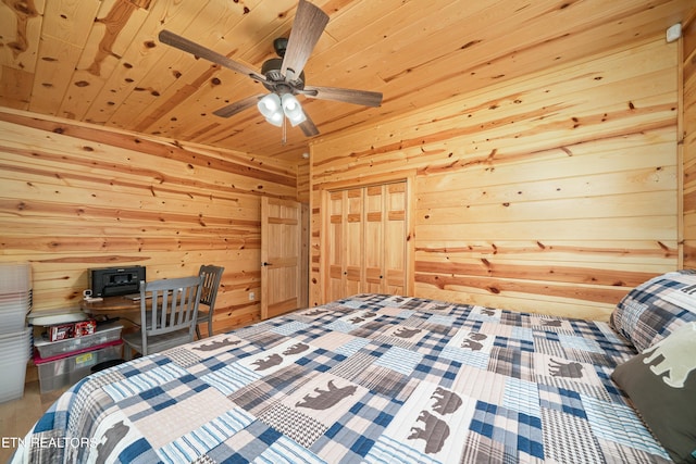 bedroom featuring a closet, wood ceiling, wood walls, and ceiling fan