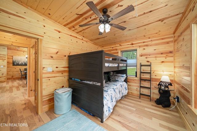 bedroom featuring lofted ceiling, ceiling fan, wood ceiling, and wood walls