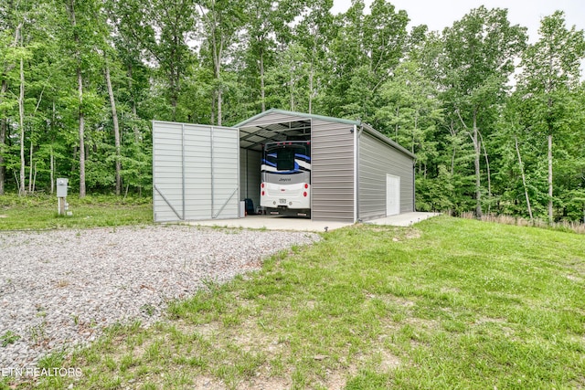 view of outbuilding featuring a carport and a yard