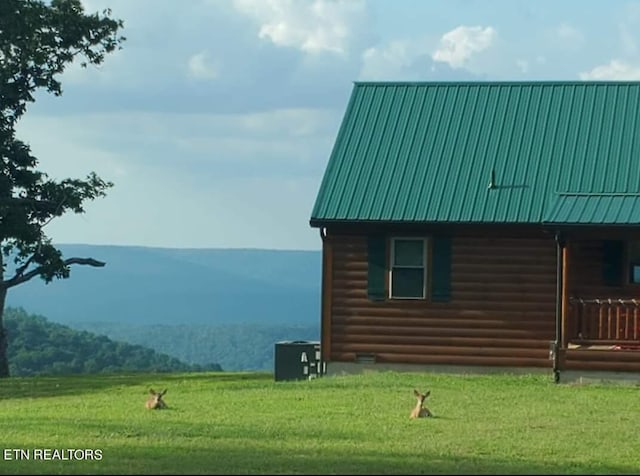 view of side of property featuring central AC and a yard