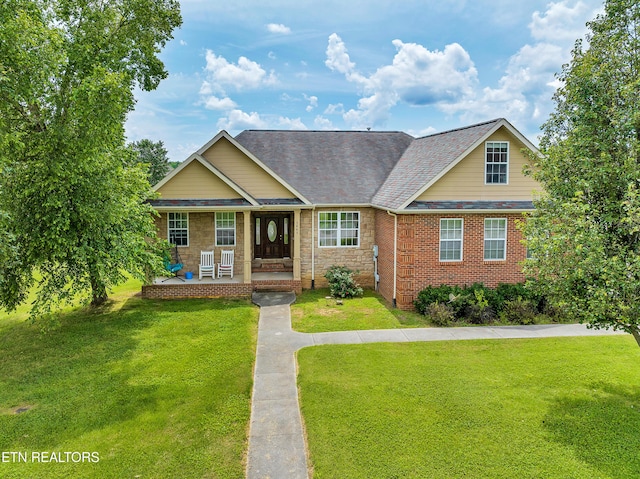 view of front of home featuring covered porch and a front yard