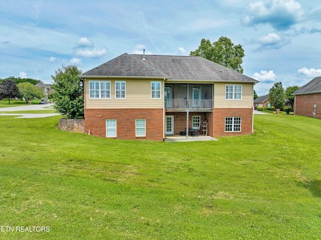 rear view of house with a yard and a patio