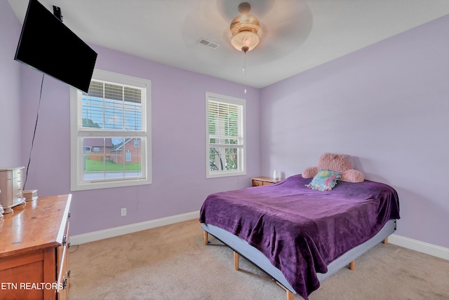 bedroom with ceiling fan and light colored carpet