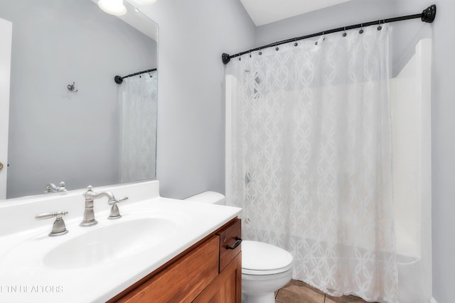 bathroom with toilet, vanity, tile patterned flooring, and a shower with shower curtain