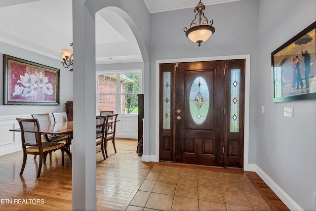 tiled foyer entrance featuring a notable chandelier