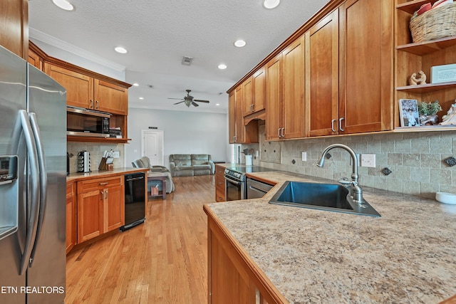 kitchen featuring ceiling fan, decorative backsplash, sink, light hardwood / wood-style flooring, and stainless steel appliances