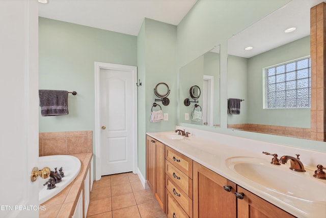 bathroom featuring vanity, tile patterned floors, and a relaxing tiled tub