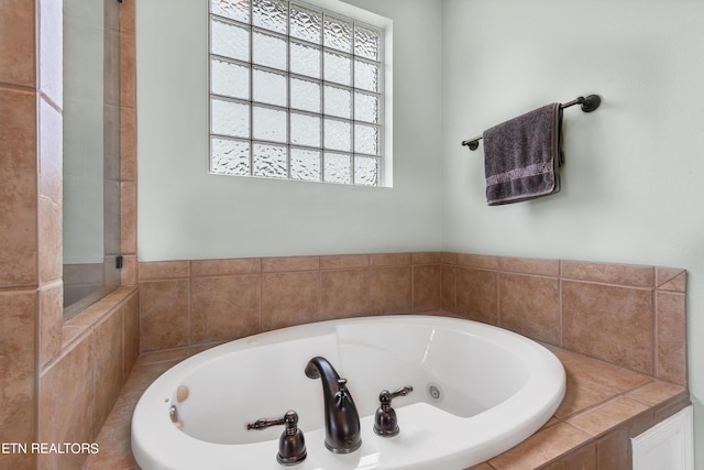 bathroom featuring a relaxing tiled tub