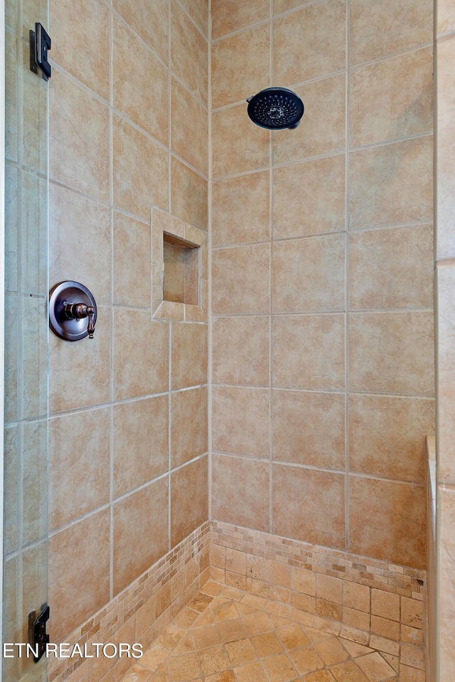 bathroom with a tile shower