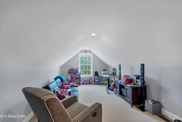 interior space with lofted ceiling, light carpet, and a textured ceiling