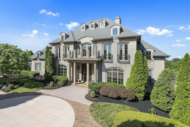 french provincial home with a balcony