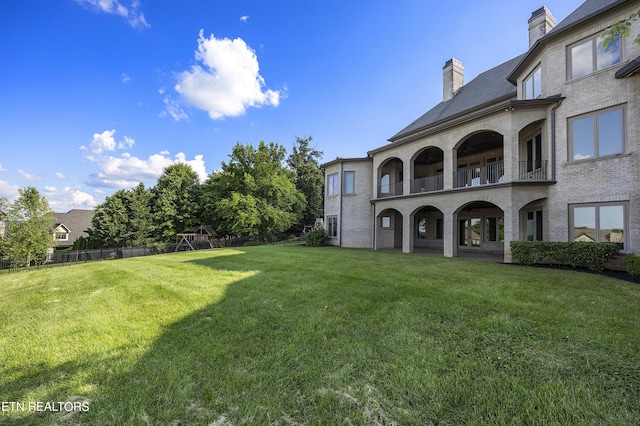 view of yard with a balcony