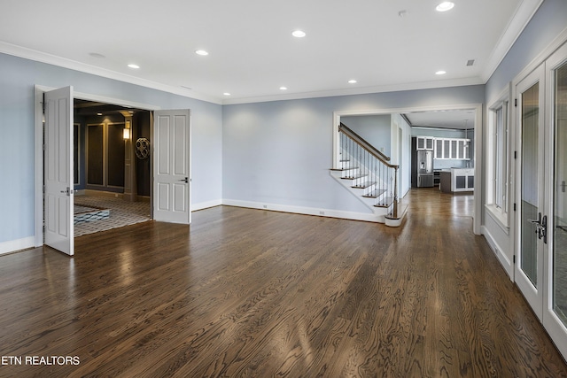 spare room with french doors, dark hardwood / wood-style flooring, and ornamental molding