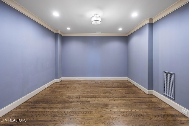 unfurnished room with crown molding and dark wood-type flooring