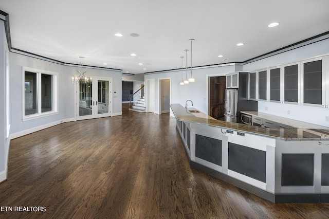 kitchen featuring sink, decorative light fixtures, dark hardwood / wood-style floors, crown molding, and stainless steel fridge