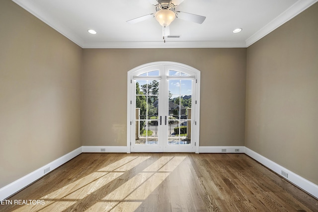 spare room with ceiling fan, french doors, hardwood / wood-style floors, and crown molding