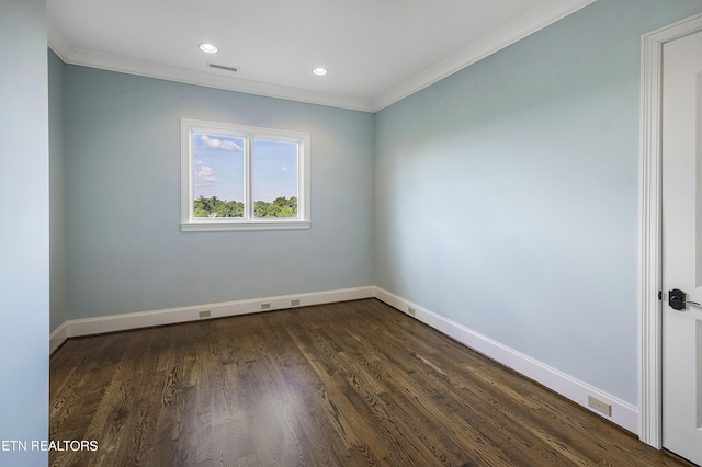 empty room featuring ornamental molding and dark hardwood / wood-style floors