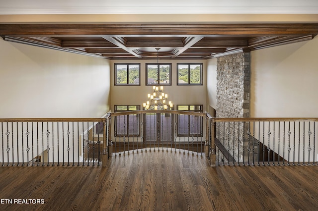 stairs featuring coffered ceiling, a chandelier, hardwood / wood-style floors, crown molding, and beamed ceiling