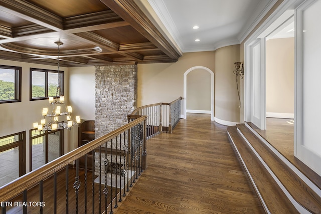 hallway featuring coffered ceiling, a chandelier, crown molding, beamed ceiling, and dark hardwood / wood-style floors