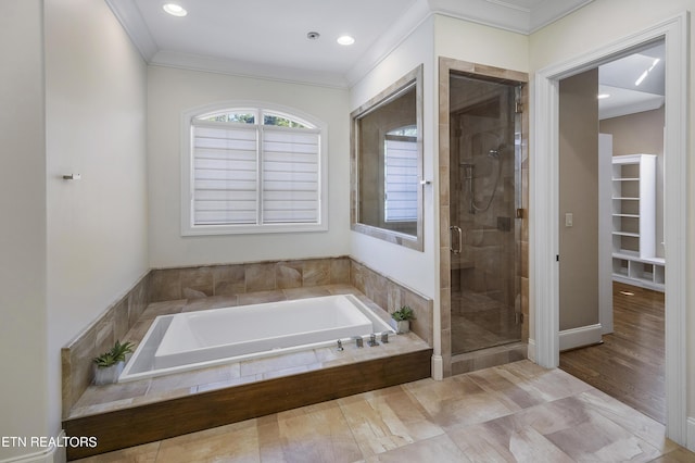 bathroom with shower with separate bathtub and ornamental molding