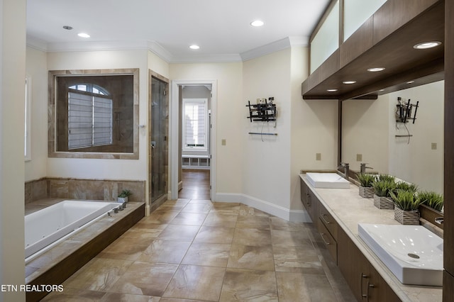 bathroom with vanity, ornamental molding, and separate shower and tub