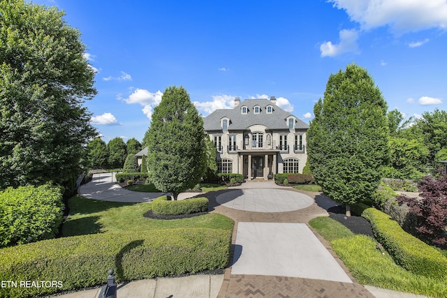 french country style house with a front yard