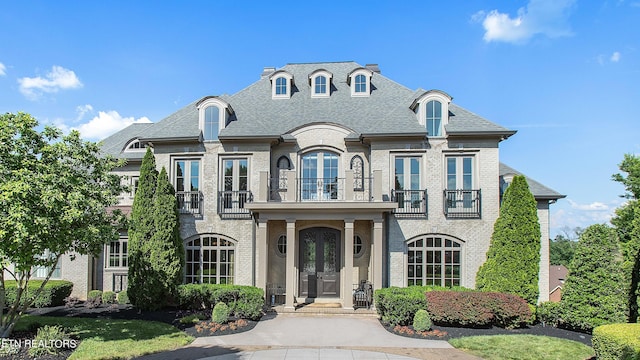 french country style house with a balcony