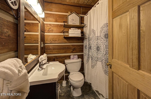 bathroom with vanity, toilet, wooden ceiling, and wooden walls