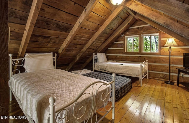 bedroom with hardwood / wood-style flooring, vaulted ceiling, and wooden ceiling